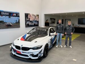 Gianni van de Craats und Victor Nielsen mit BMW M4 GT4 von FK Performance Motorsport im Showroom